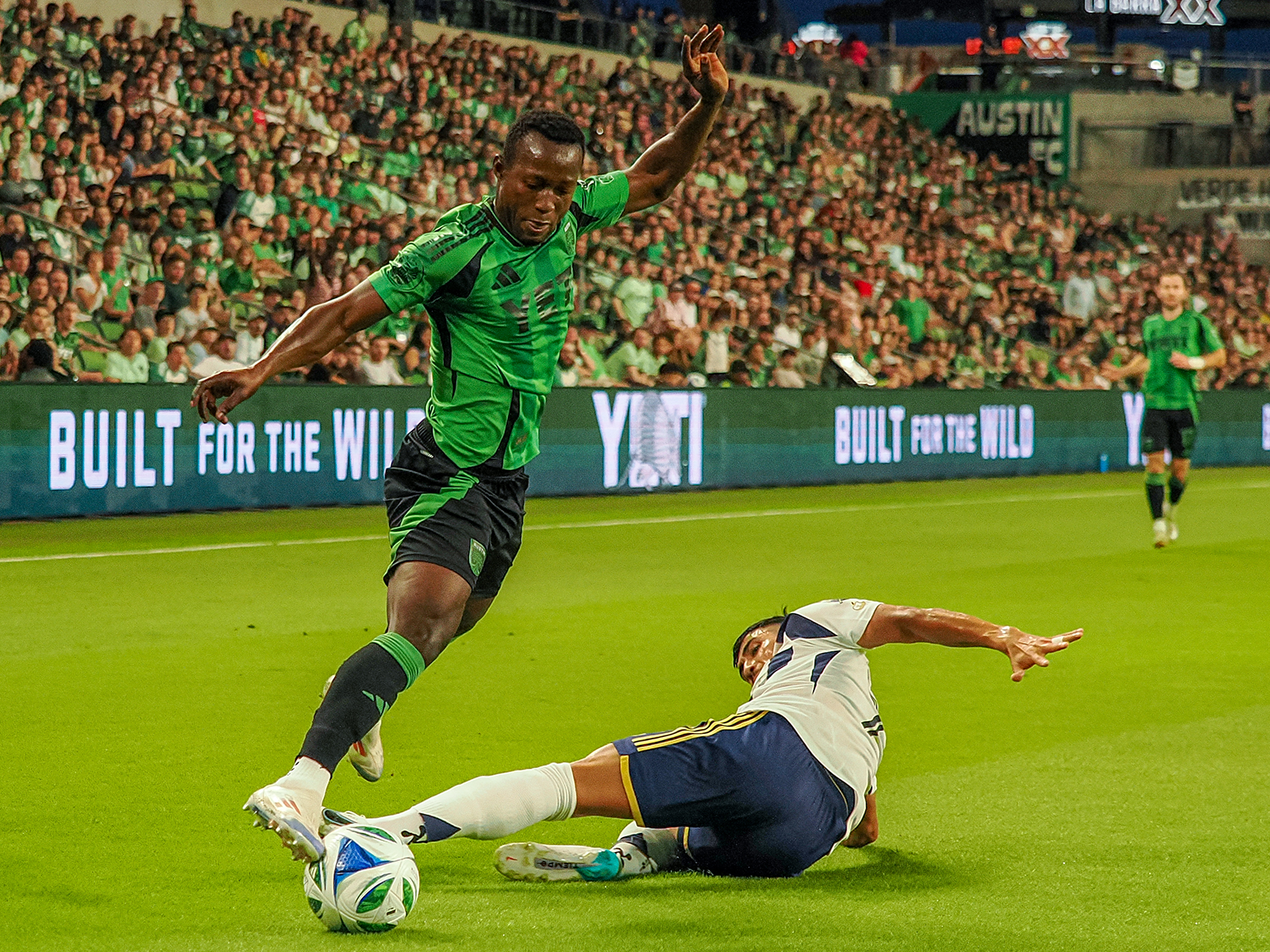 Osman Bukari getting around an RSL defender (first of three photos) 