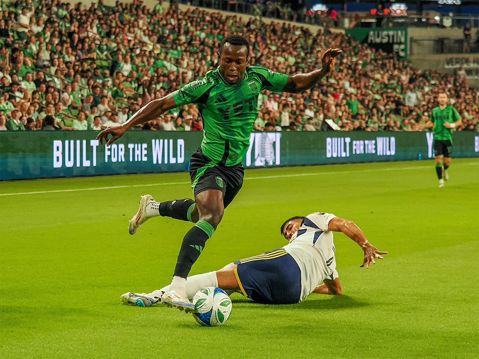 Osman Bukari getting around an RSL defender (second of three photos) 