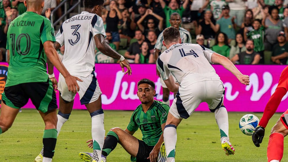 Owen Wolff sitting on the turf after drawing contact in the box against the New England Revolution and not getting the foul called