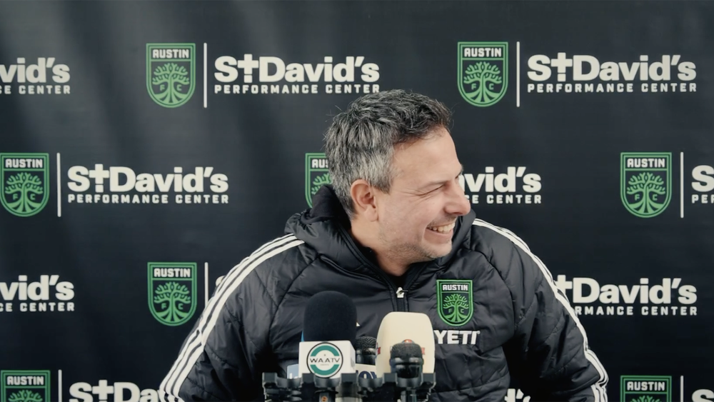 Austin FC head coach Nico Estévez laughing at a press conference