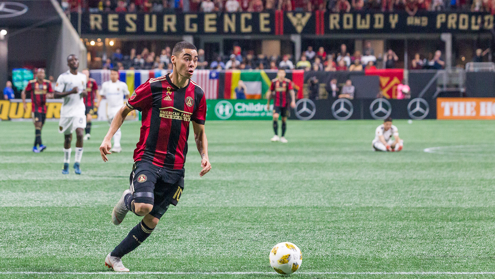 Miguel Almiron of Atlanta United dribbing in his home stadium