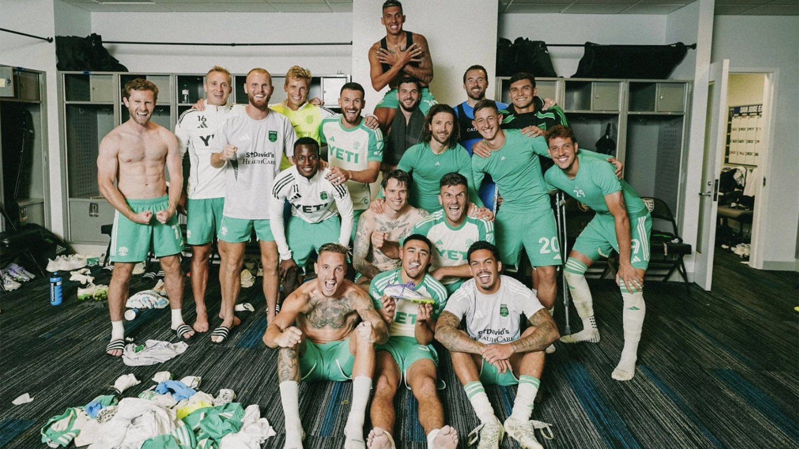 Austin FC players posing in locker room after Open Cup win over San Jose