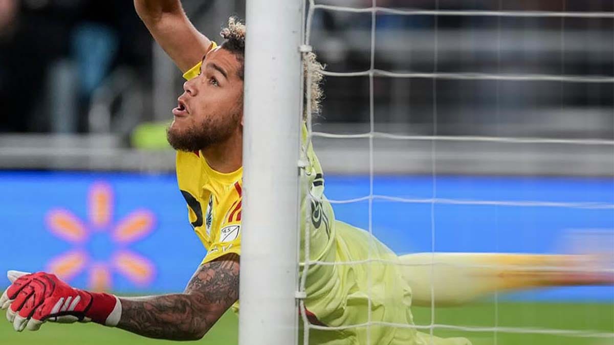 Minnesota goalkeeper Dayne St. Clair diving toward goal