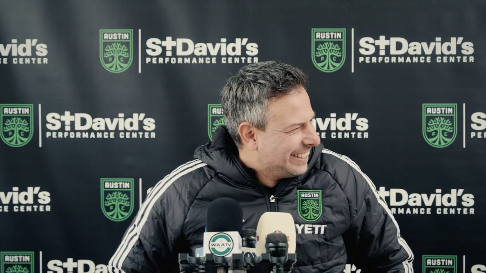 Austin FC head coach Nico Estévez laughing at a press conference