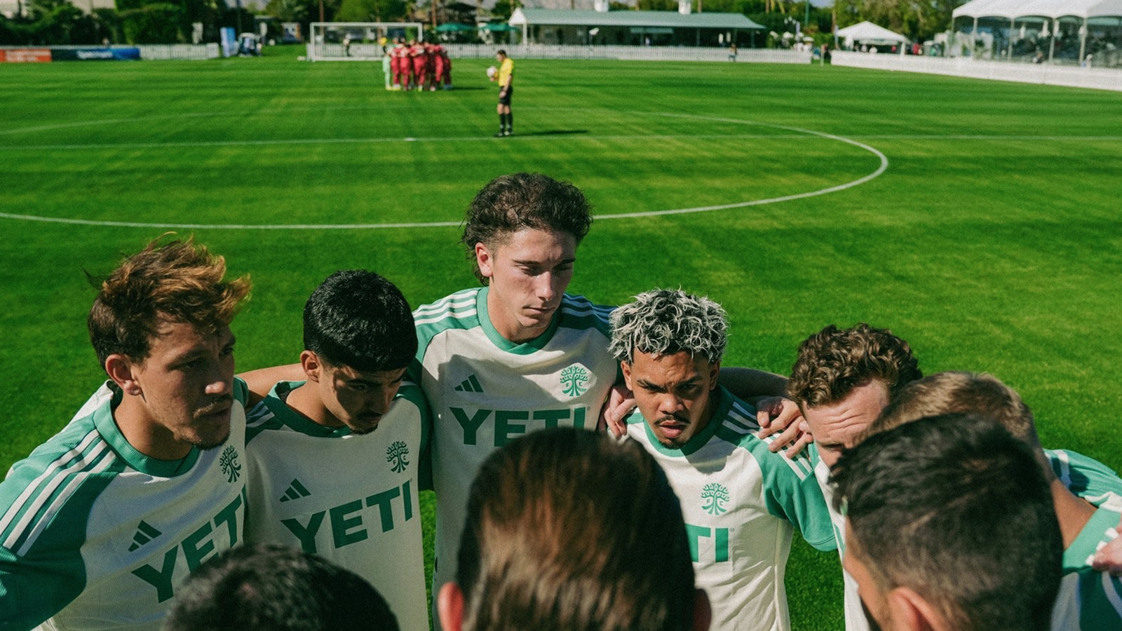Austin FC players huddle at a Coachella match against St. Louis