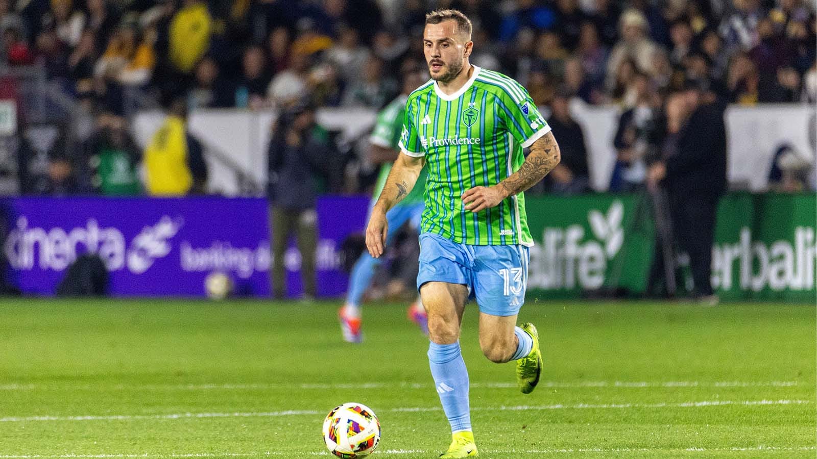 Jordan Morris dribbling a soccer ball in a match