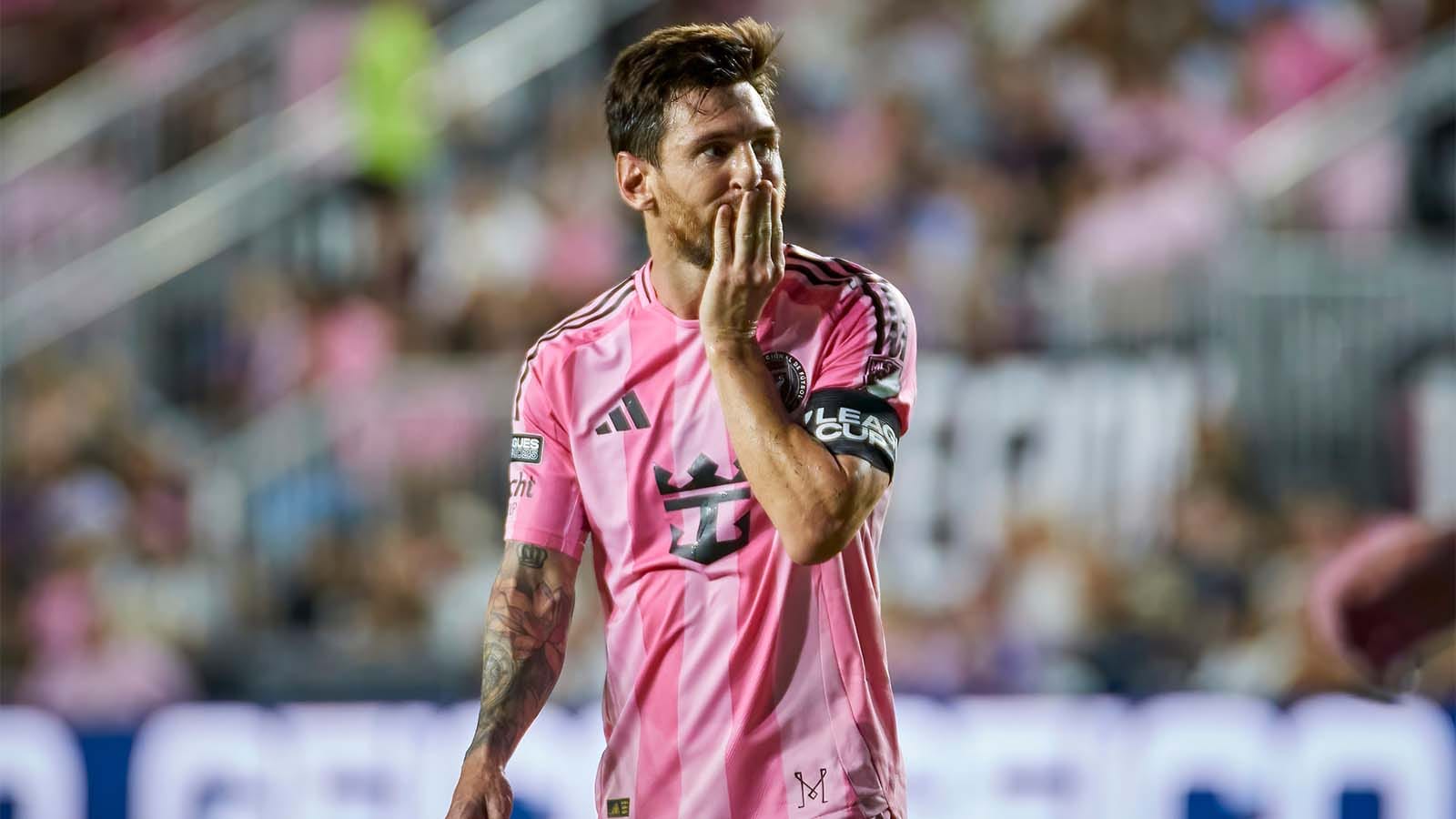 Lionel Messi with hand over mouth in a Leagues Cup match
