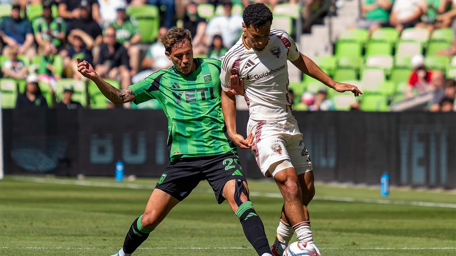 Guilherme Biro defending against a D.C. United player 